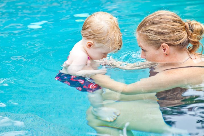 Swim instructor teaching water safety to a child in Palm Beach County